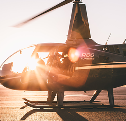 Helicopter glistening in the sunset or sunrise.